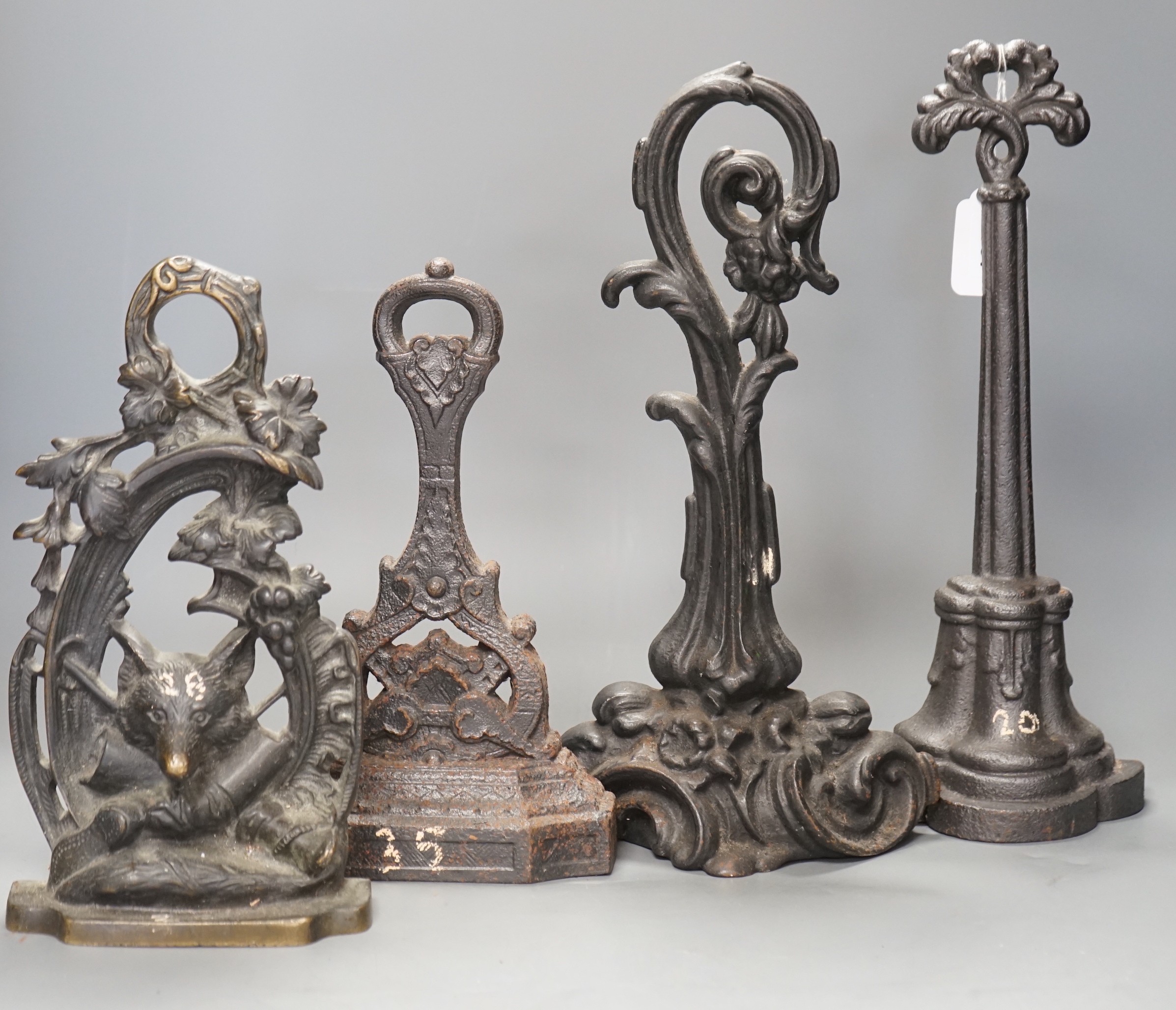 Four assorted Victorian cast iron doorstops, tallest 38cm